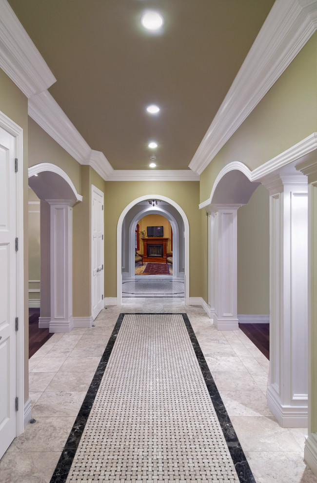 Design ideas for a mid-sized traditional hallway in New York with green walls, travertine floors and multi-coloured floor.