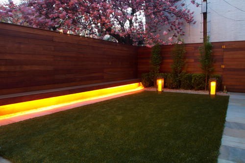 Here is a backyard with an interesting lighting setup. There is a long light placed underneath a bench making the underside of the bench glow. This is great for an ambient light and a warm welcoming appeal. 
