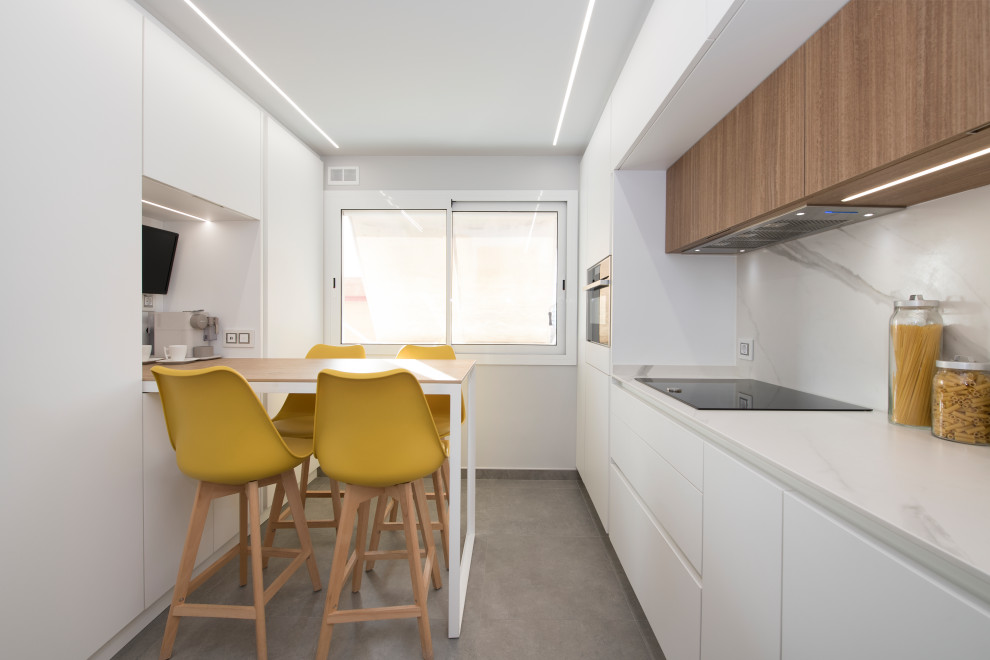 Large scandinavian galley separate kitchen in Other with a single-bowl sink, flat-panel cabinets, white cabinets, quartz benchtops, white splashback, black appliances, terra-cotta floors, no island, grey floor and white benchtop.