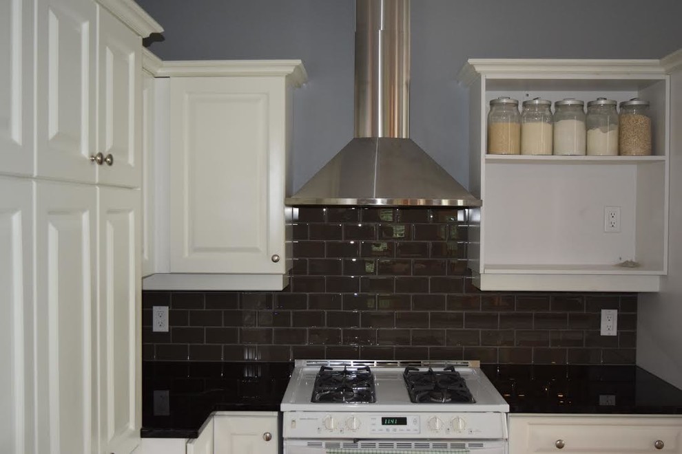 Example of a mid-sized transitional kitchen design in Ottawa with raised-panel cabinets, white cabinets, brown backsplash, subway tile backsplash, white appliances and solid surface countertops