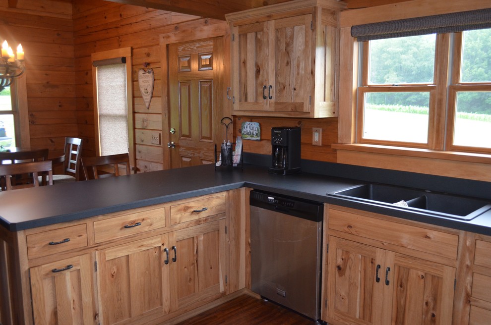 Eat-in kitchen - mid-sized rustic u-shaped dark wood floor and brown floor eat-in kitchen idea with a drop-in sink, recessed-panel cabinets, light wood cabinets, solid surface countertops, stainless steel appliances and a peninsula
