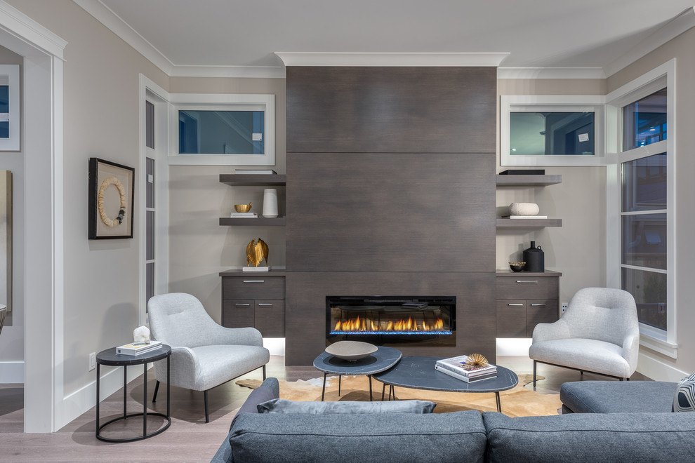 This is an example of a large contemporary open concept living room in Vancouver with beige walls, medium hardwood floors, a wood fireplace surround, no tv, brown floor and a ribbon fireplace.