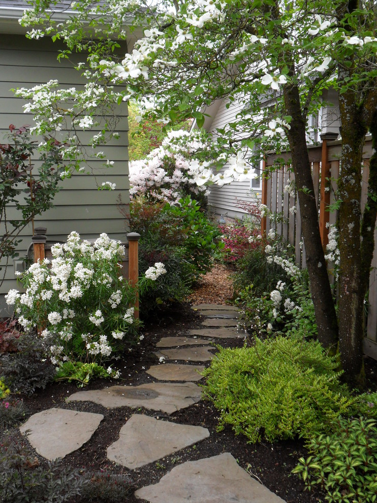 Design ideas for a small traditional backyard partial sun garden for spring in Portland with a garden path and natural stone pavers.