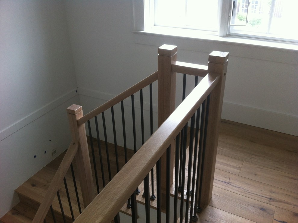 Example of a mid-sized classic wooden l-shaped metal railing staircase design in Other with painted risers