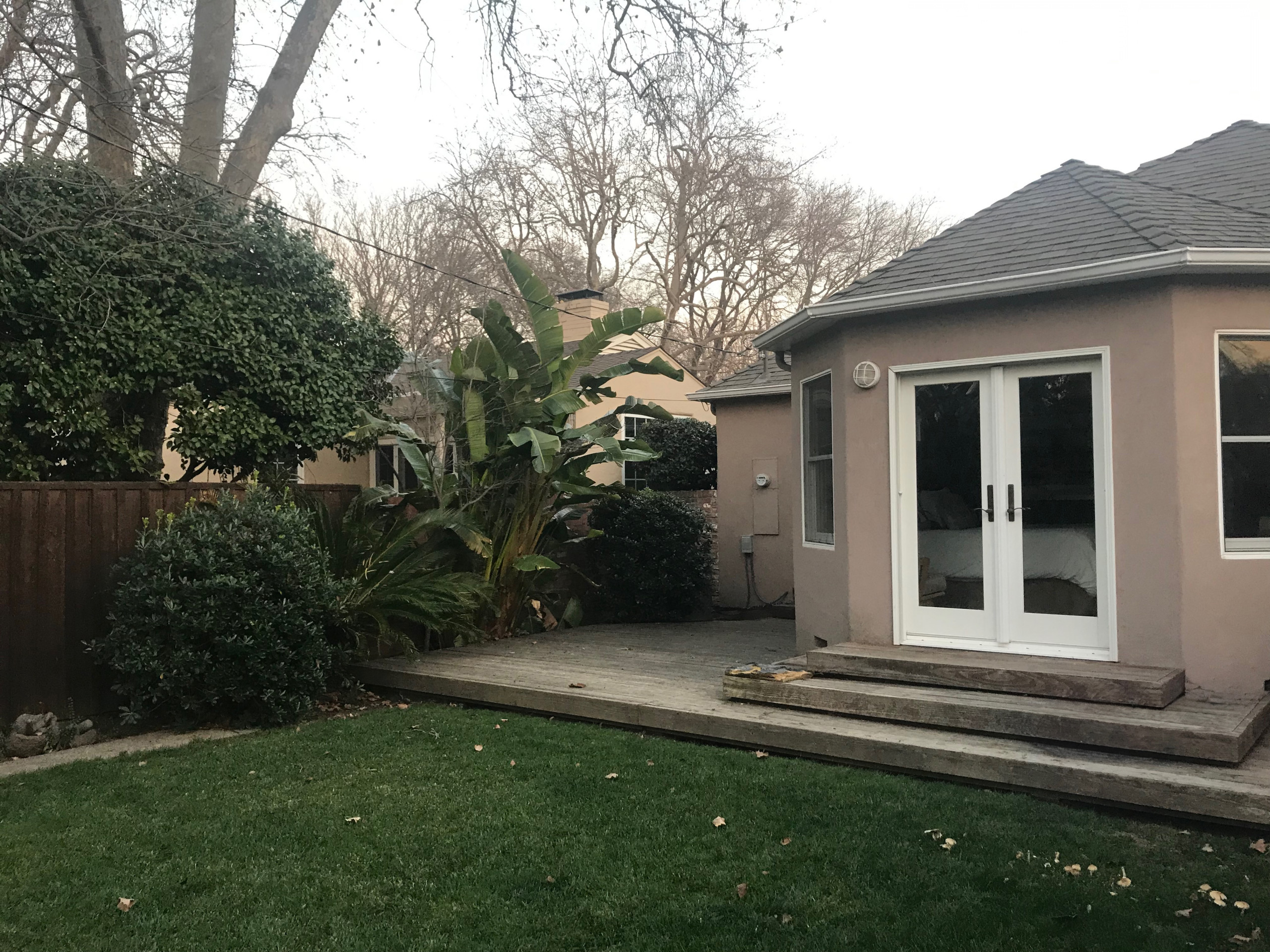 Before: Oversized Vegetation and Cramped Wood Deck