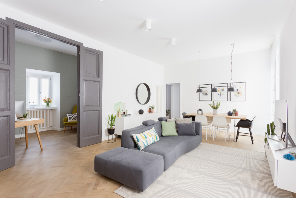 Mid-sized scandinavian enclosed living room in Rome with white walls, a freestanding tv and beige floor.