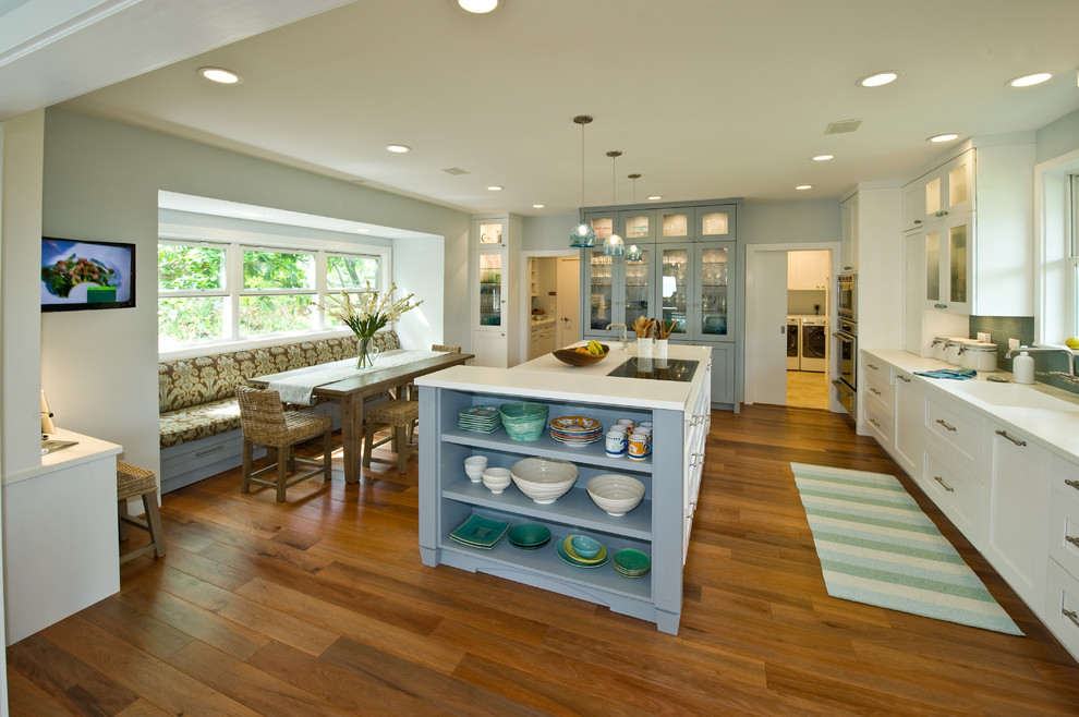 Tropical kitchen pantry in Hawaii with an integrated sink, shaker cabinets, white cabinets, solid surface benchtops, blue splashback, glass tile splashback, panelled appliances and with island.