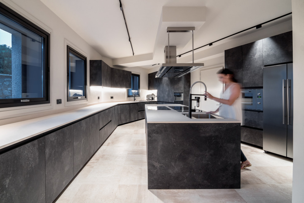 Inspiration for an expansive contemporary kitchen in Cagliari with an integrated sink, flat-panel cabinets, stainless steel appliances, ceramic floors, with island and white benchtop.