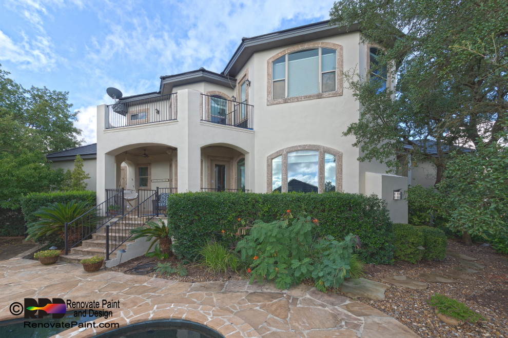 Huge mediterranean beige two-story stucco house exterior idea in Austin