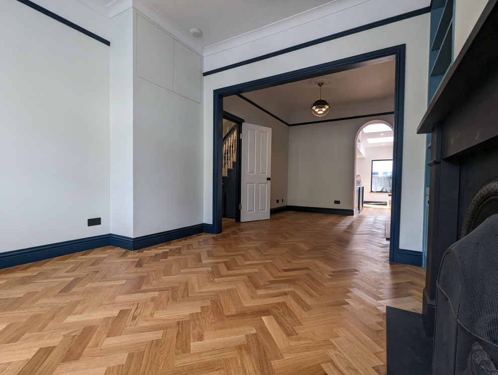 Design ideas for a medium sized victorian living room in London with light hardwood flooring.