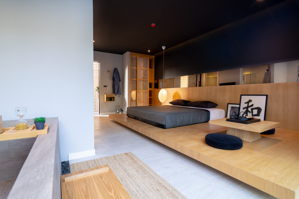 Design ideas for a small asian guest bedroom with black walls, ceramic floors and grey floor.