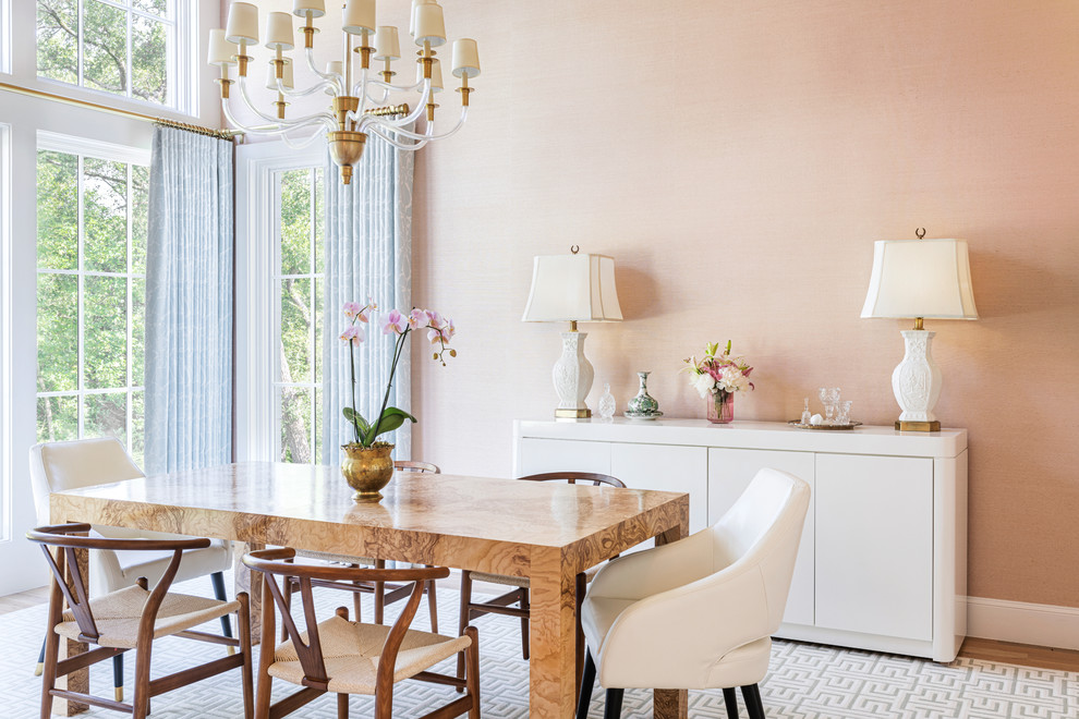 Large transitional separate dining room in Dallas with pink walls, light hardwood floors and no fireplace.