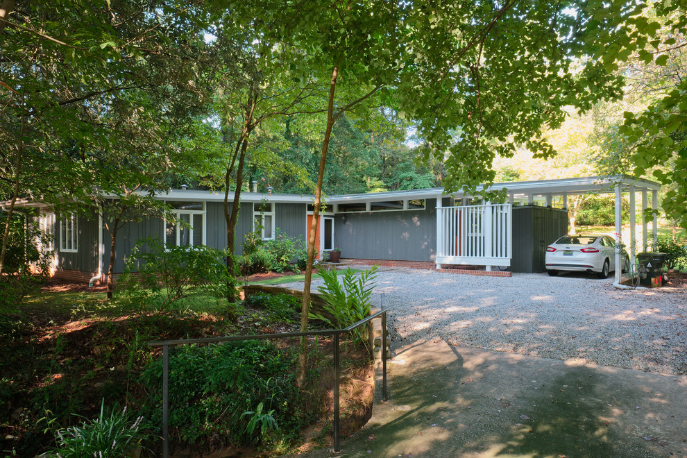 Inspiration for a mid-sized midcentury one-storey green exterior in Atlanta with wood siding and a flat roof.