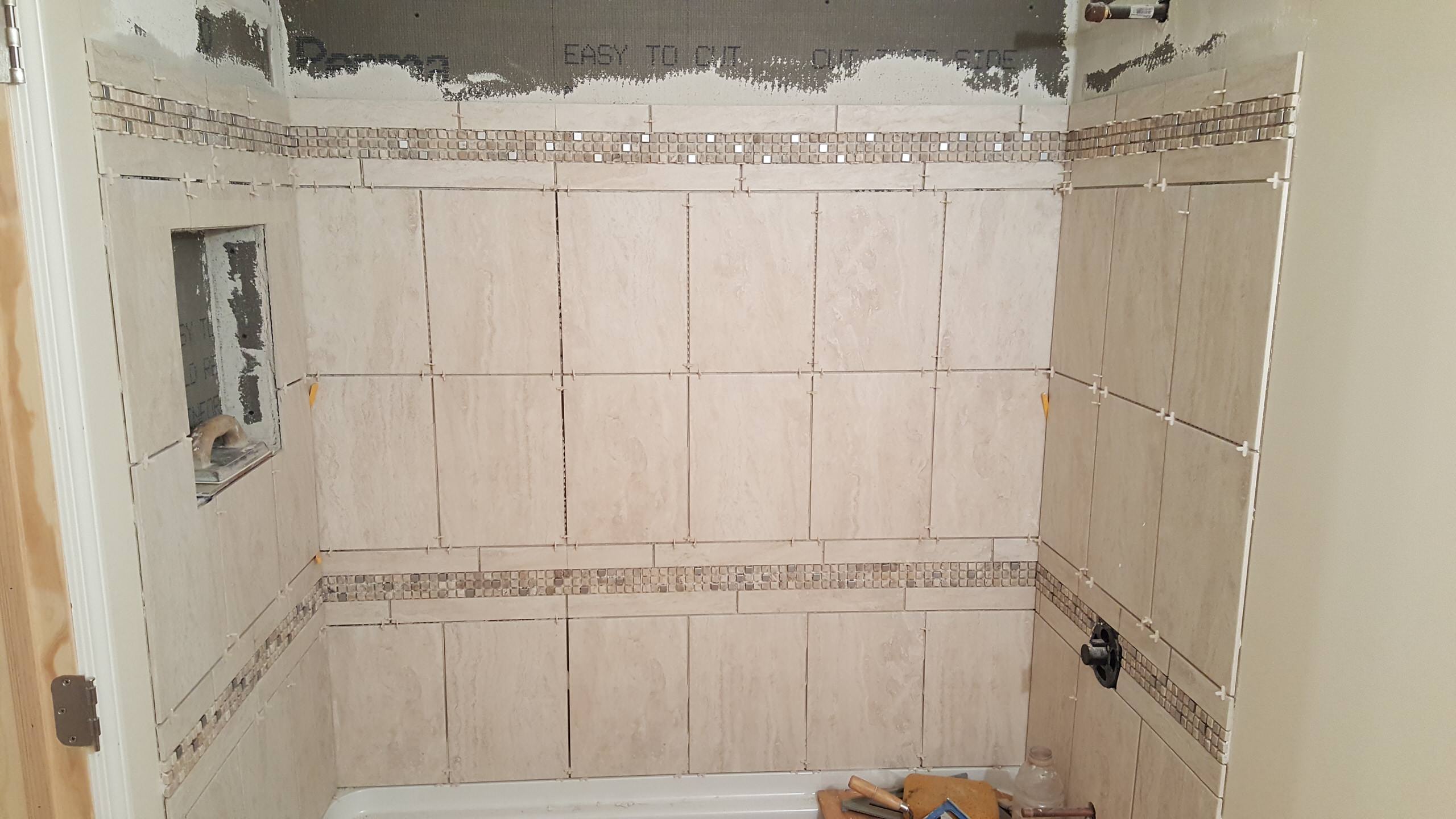 Shower tile getting installed
