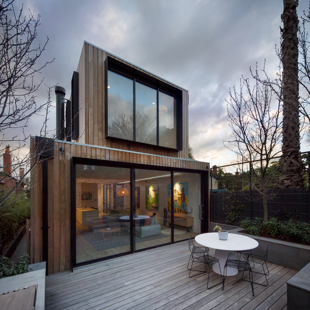 Contemporary backyard deck in Melbourne with no cover.