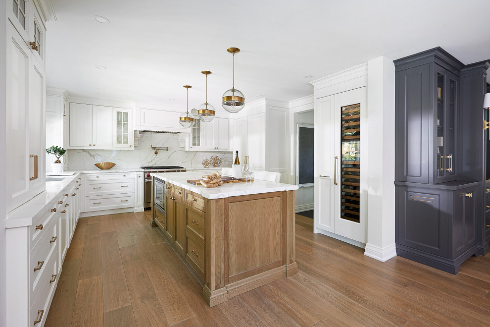 Inspiration for a large transitional u-shaped light wood floor open concept kitchen remodel in Toronto with recessed-panel cabinets, white cabinets, white backsplash, an island and white countertops