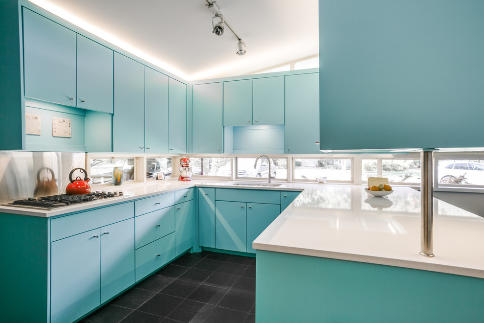 Inspiration for a mid-sized midcentury u-shaped separate kitchen in Dallas with an undermount sink, slate floors, black floor, flat-panel cabinets, blue cabinets, quartz benchtops, window splashback and stainless steel appliances.