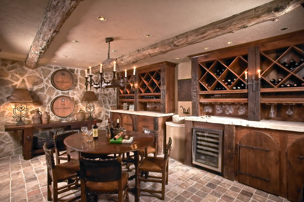 Photo of a large mediterranean wine cellar in Houston with brick floors, diamond bins and red floor.