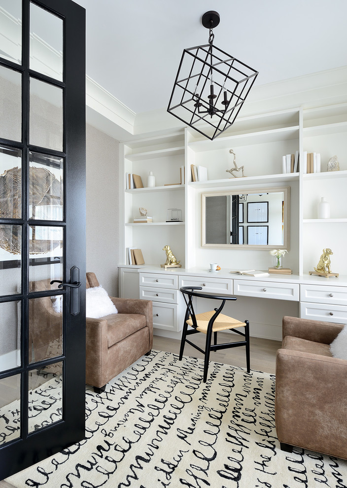 Inspiration for a transitional home office in Montreal with grey walls, a built-in desk and brown floor.