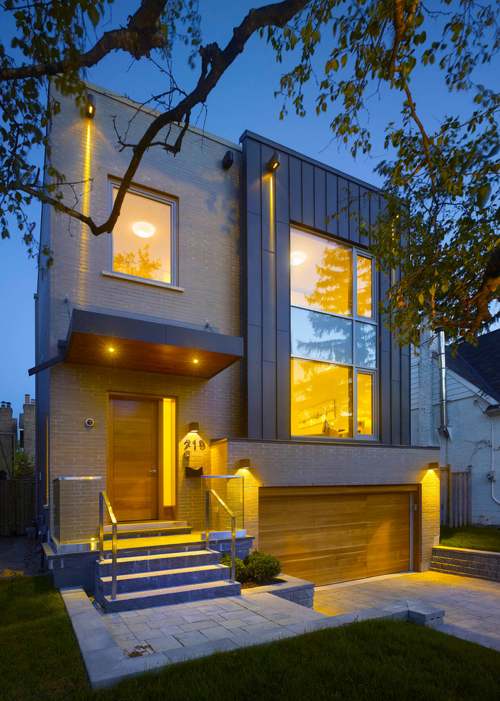 This is an example of a contemporary exterior in Toronto with mixed siding.