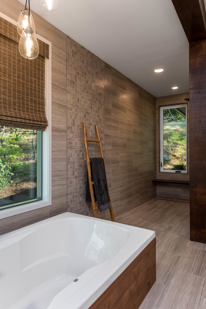 Design ideas for a mid-sized country master bathroom in Other with white cabinets, a freestanding tub, an alcove shower, a two-piece toilet, beige tile, mosaic tile, beige walls, porcelain floors, a trough sink, soapstone benchtops, beige floor and black benchtops.