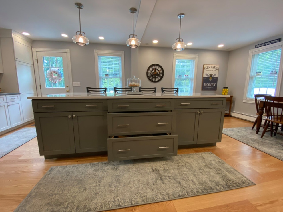 Example of a mid-sized transitional eat-in kitchen design in Providence with flat-panel cabinets, quartz countertops and an island
