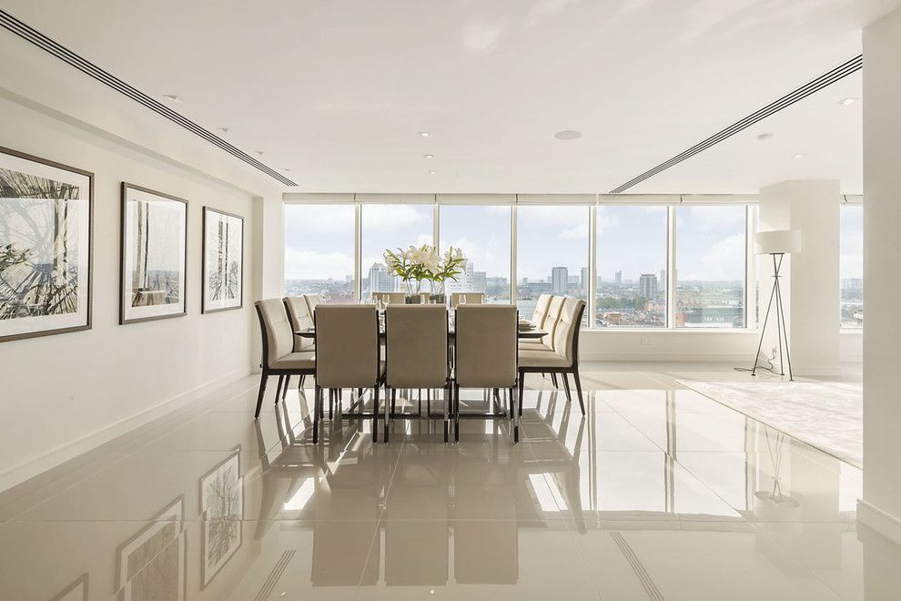 Design ideas for an expansive contemporary dining room in London with beige walls and porcelain floors.