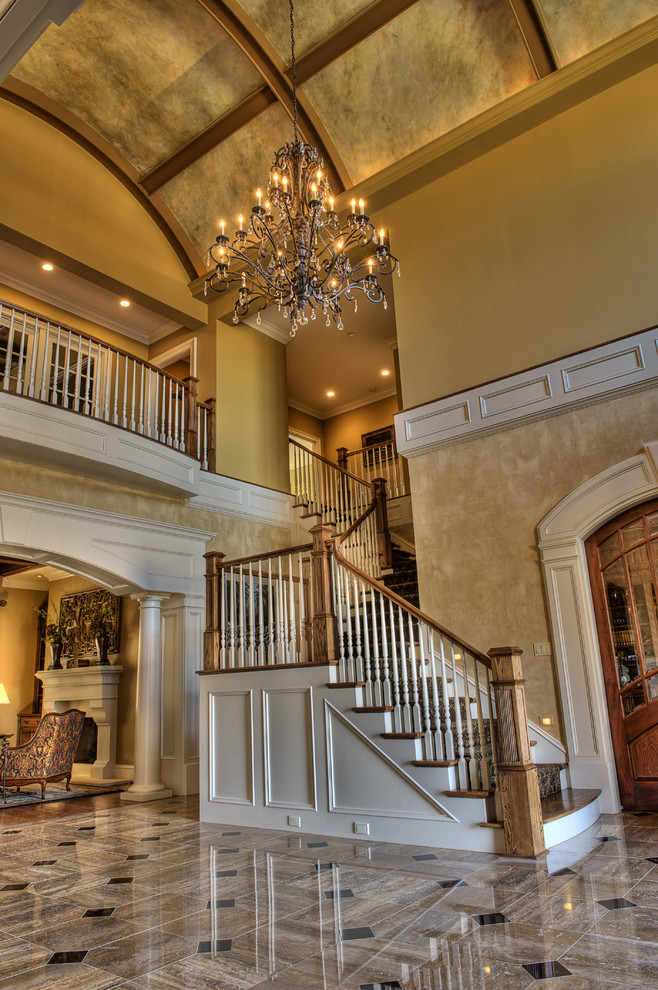 Design ideas for an expansive traditional foyer in Other with yellow walls and limestone floors.