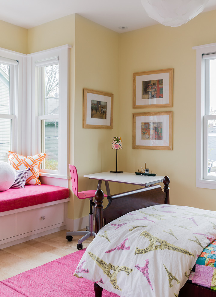 Design ideas for a mid-sized scandinavian kids' bedroom for girls in Boston with yellow walls and light hardwood floors.