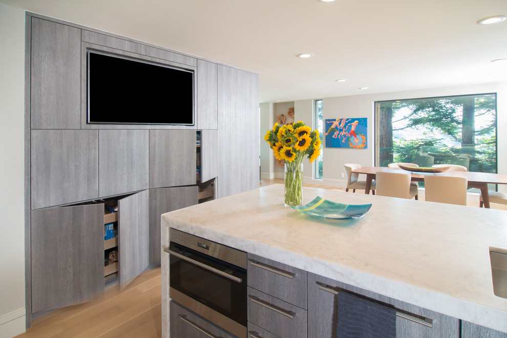 Contemporary galley kitchen in San Francisco with flat-panel cabinets and light wood cabinets.
