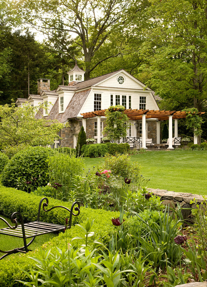 Design ideas for a large traditional three-storey white exterior in New York with a gambrel roof.