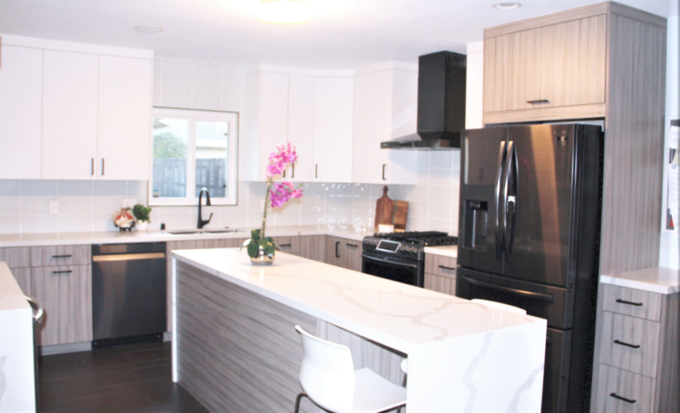 Inspiration for a mid-sized transitional u-shaped porcelain tile and brown floor eat-in kitchen remodel in Atlanta with a double-bowl sink, flat-panel cabinets, white cabinets, quartz countertops, white backsplash, glass tile backsplash, black appliances, an island and white countertops