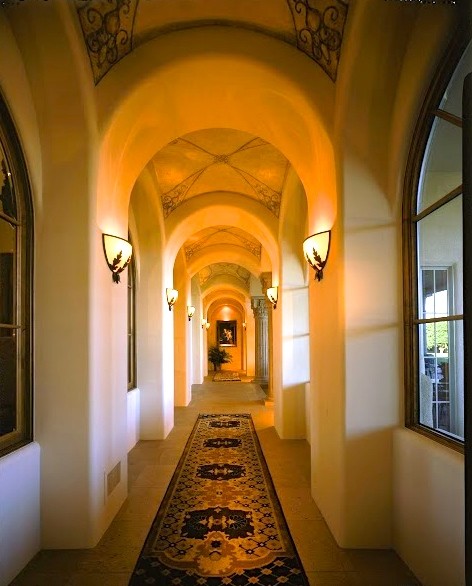 Inspiration for an expansive mediterranean hallway in Phoenix with beige walls and porcelain floors.