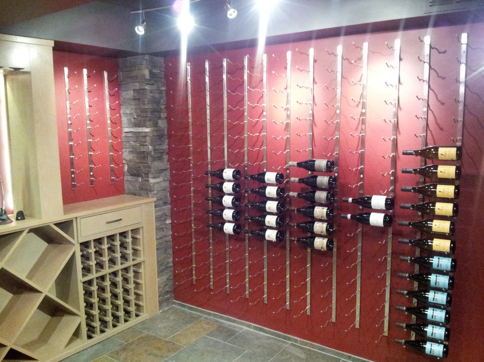Photo of a large contemporary wine cellar in Denver with slate floors and display racks.