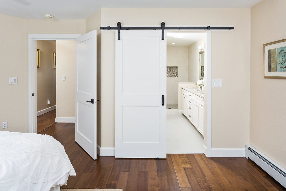 Example of a large transitional master medium tone wood floor bedroom design with beige walls