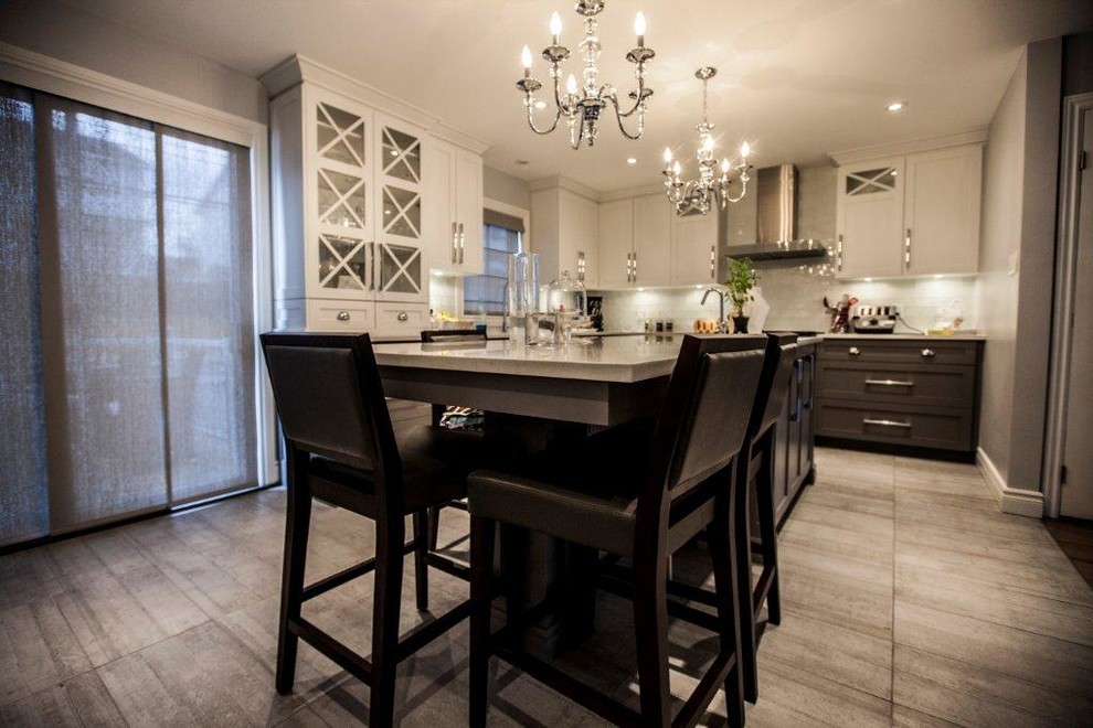 Photo of a mid-sized traditional l-shaped separate kitchen in Montreal with a double-bowl sink, glass-front cabinets, white cabinets, granite benchtops, black splashback, subway tile splashback, stainless steel appliances, concrete floors and with island.