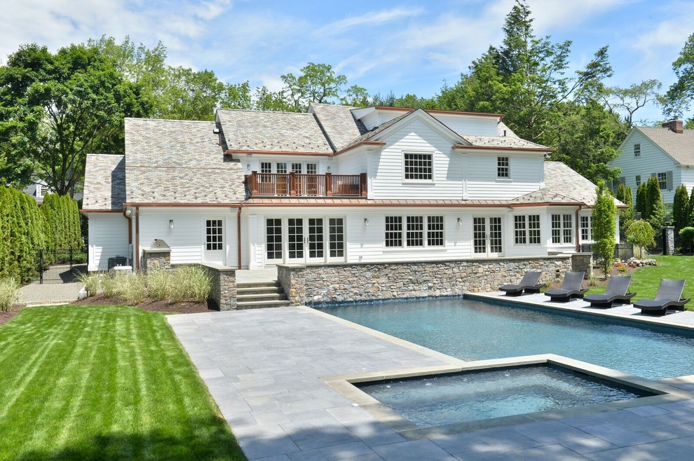 Inspiration for a large transitional backyard stone and rectangular lap hot tub remodel in New York