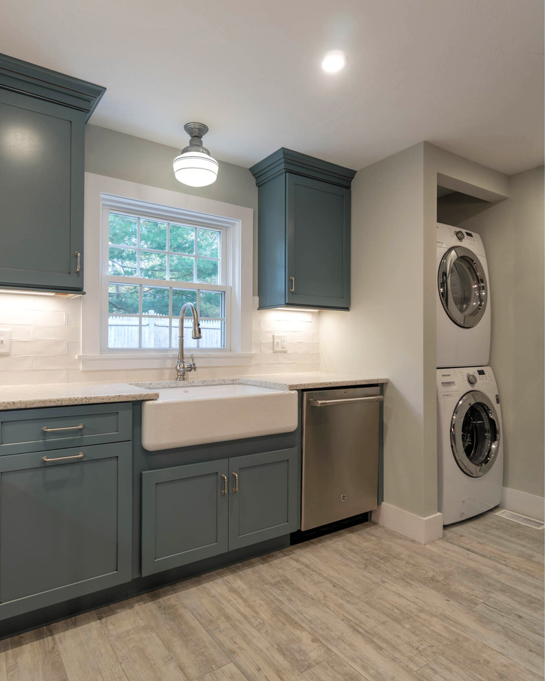 Photo of a small modern l-shaped kitchen pantry in Boston with a farmhouse sink, shaker cabinets, blue cabinets, recycled glass benchtops, white splashback, ceramic splashback, stainless steel appliances, ceramic floors, with island and beige floor.