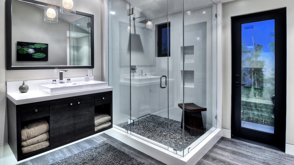 Mid-sized modern bathroom in Orange County with a trough sink, flat-panel cabinets, dark wood cabinets, granite benchtops, white walls, dark hardwood floors and with a sauna.
