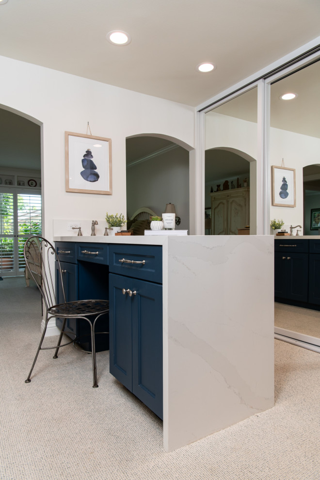 Inspiration for a transitional master porcelain tile, brown floor and double-sink walk-in shower remodel in Orange County with shaker cabinets, blue cabinets, white walls, an undermount sink, quartz countertops, a hinged shower door, white countertops and a built-in vanity