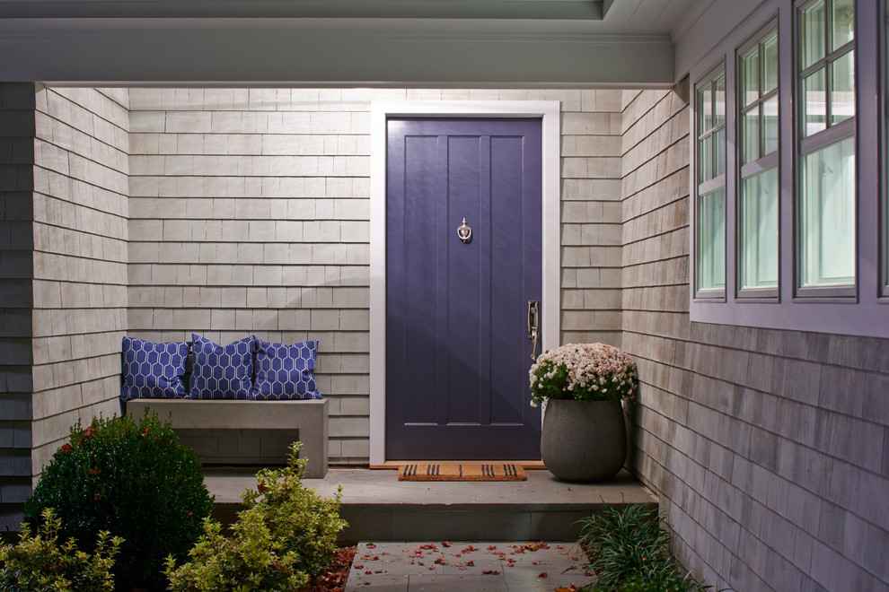 Mid-sized beach style front door in New York with grey walls, concrete floors, a single front door and a blue front door.