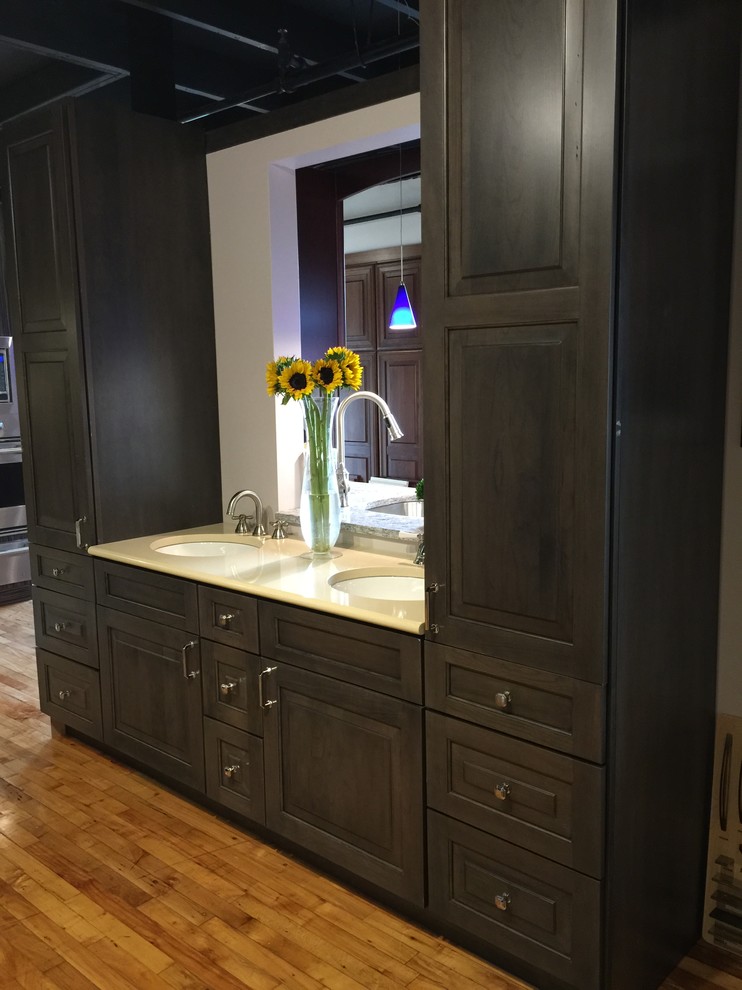 Bathroom - large transitional master medium tone wood floor bathroom idea in Boston with raised-panel cabinets, black cabinets, solid surface countertops and beige countertops