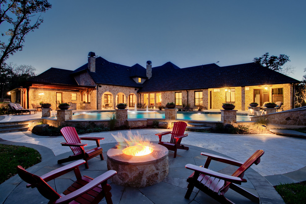 Inspiration for a traditional backyard patio in Dallas with a fire feature.
