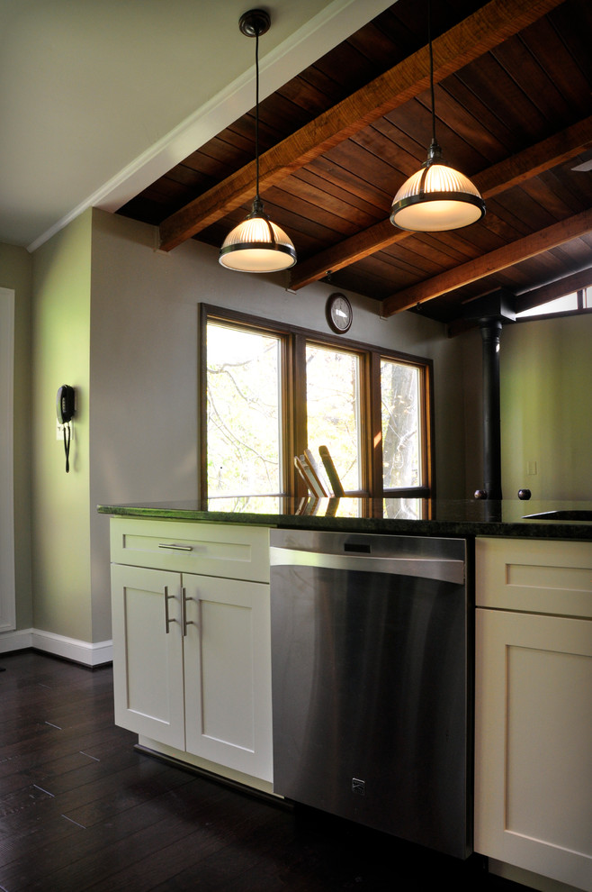 Eat-in kitchen - mid-sized transitional u-shaped dark wood floor eat-in kitchen idea in DC Metro with an undermount sink, shaker cabinets, white cabinets, granite countertops, yellow backsplash, glass tile backsplash, stainless steel appliances and a peninsula