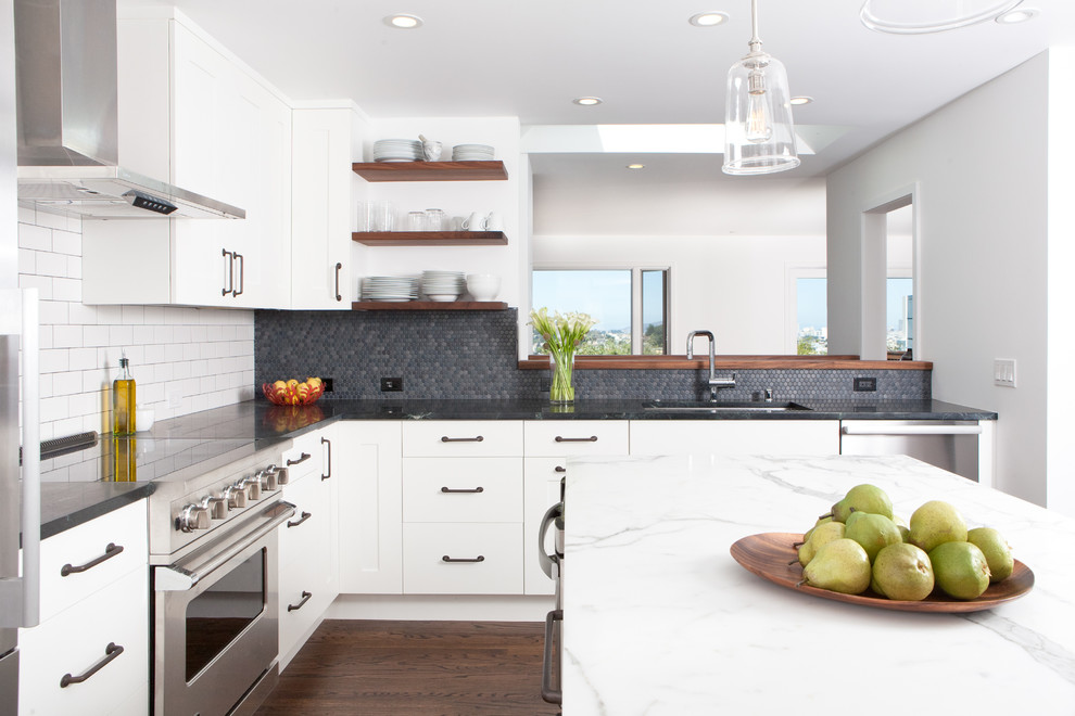 Country kitchen in San Francisco with stainless steel appliances and subway tile splashback.