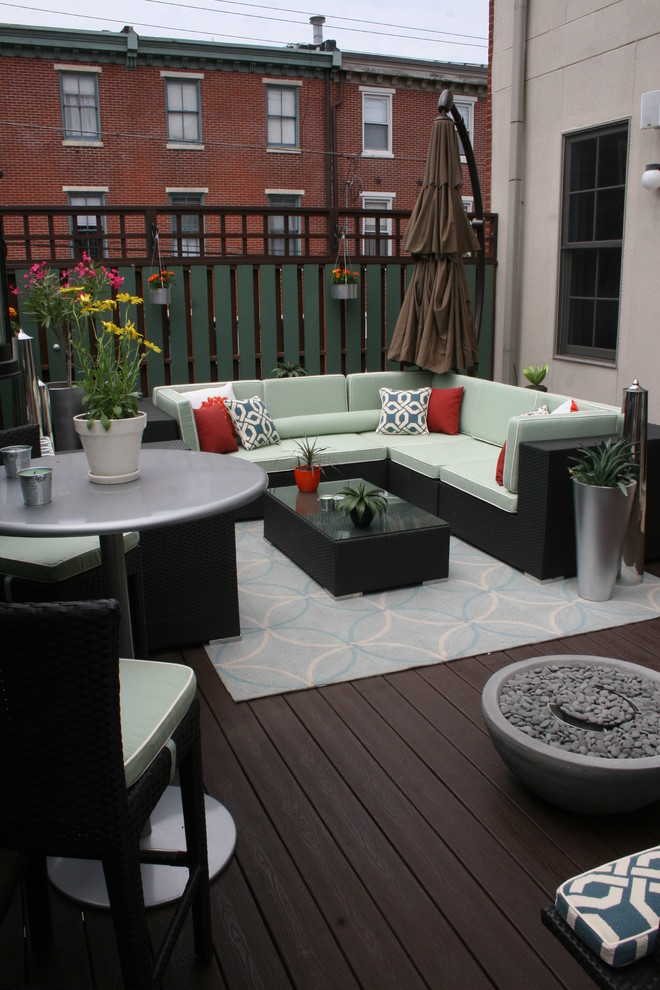 This is an example of a transitional deck in Philadelphia with a fire feature.