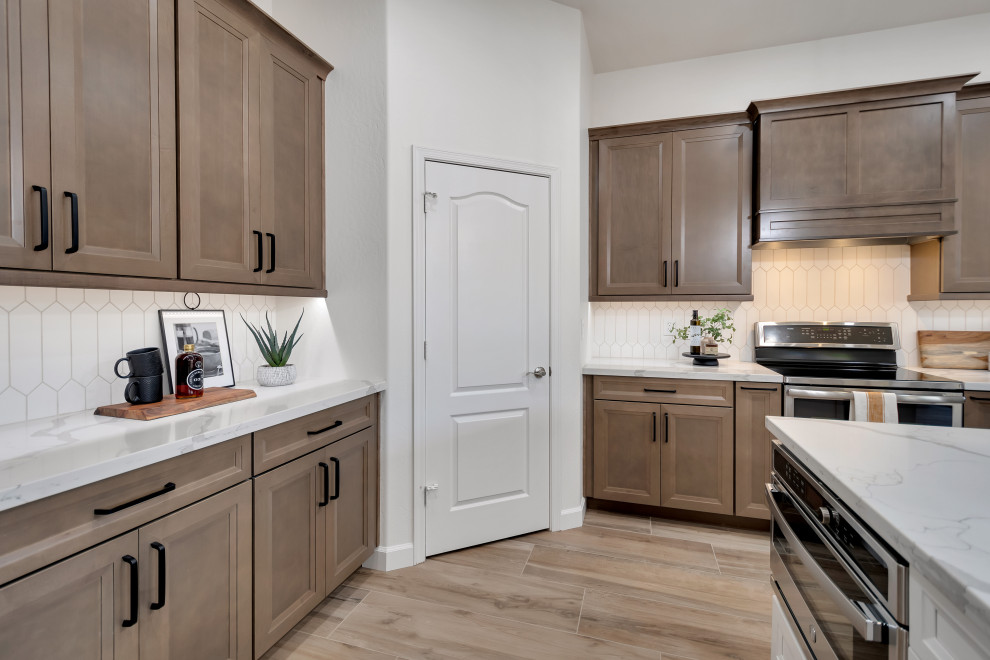 Mid-sized transitional u-shaped ceramic tile and brown floor eat-in kitchen photo in Phoenix with beaded inset cabinets, brown cabinets, quartzite countertops, white backsplash, ceramic backsplash, an island and white countertops