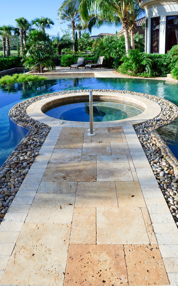 Design ideas for a mid-sized transitional backyard custom-shaped lap pool in Orlando with a hot tub and tile.