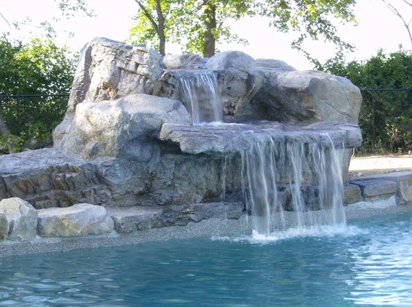 Inspiration for a large rustic backyard stone lap pool fountain remodel in Austin