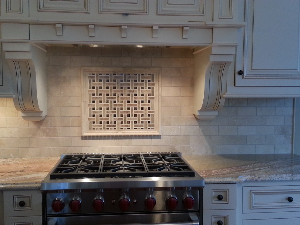 Inspiration for a mid-sized l-shaped light wood floor eat-in kitchen remodel in Newark with a drop-in sink, raised-panel cabinets, white cabinets, granite countertops, white backsplash, subway tile backsplash, stainless steel appliances and an island